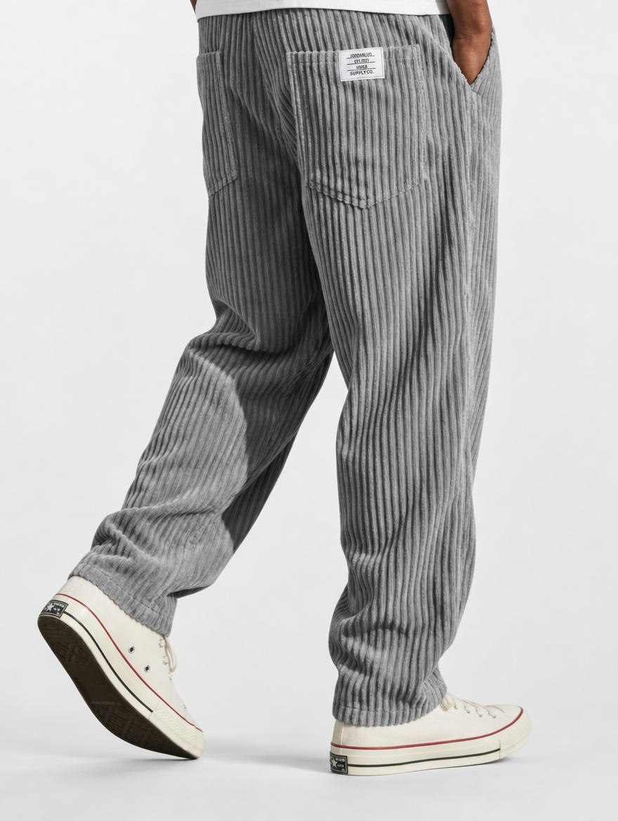 Gray striped pants worn by a person on a white background