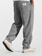 Gray striped pants worn by a person on a white background