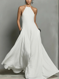 White halter neck dress on a model against a gray background