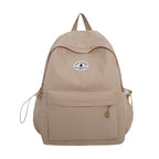 A beige gingham backpack with a front zippered pocket and a circular white brand patch, shown against a plain white background.